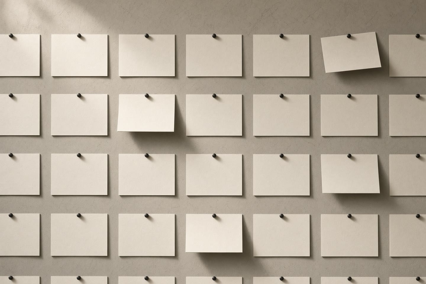 A studio wall of blank cards in a grid
